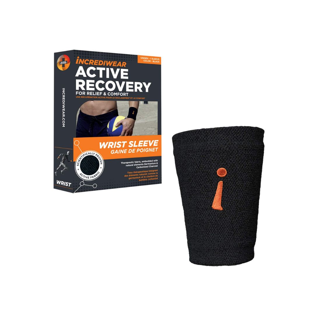 A black knit wrist sleeve with an orange logo detail, shown next to its retail packaging box by Incrediwear on a plain white background.