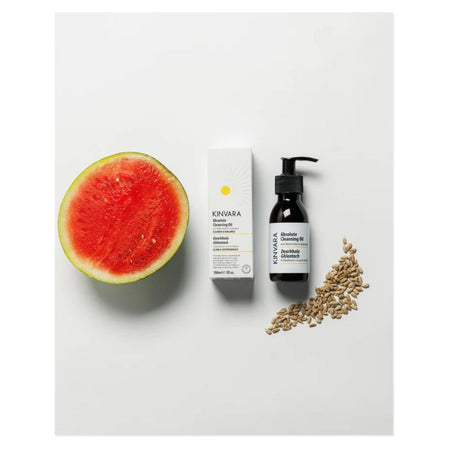 A flat-lay product shot of Kivara Shea Creamy Gel on a white background, styled with a sliced watermelon, a pile of shea seeds, and the product box and pump bottle.