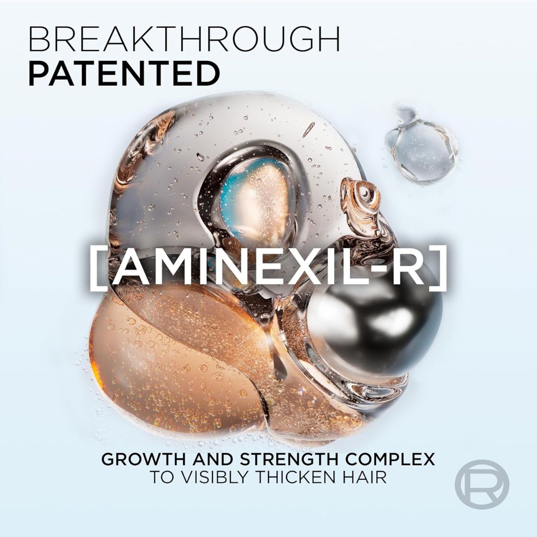 Promotional graphic for Aminexil-R, featuring a stylized translucent and metallic hair drop illustration with the text 'BREAKTHROUGH PATENTED' at the top and 'GROWTH AND STRENGTH COMPLEX TO VISIBLY THICKEN HAIR' at the bottom.