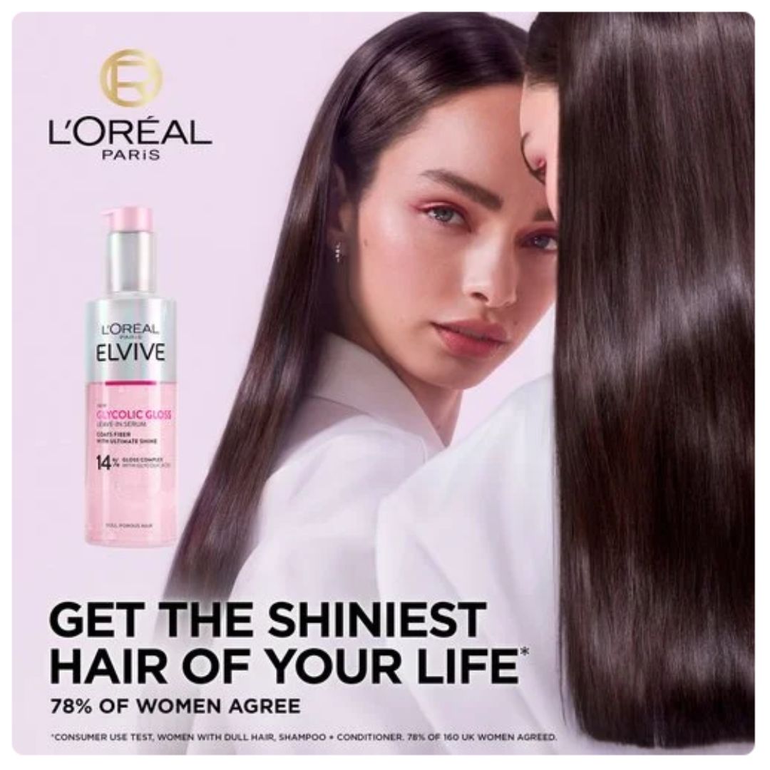L'Oréal Paris hair oil advertisement featuring a woman with long, straight, glossy dark brown hair next to the pink and silver bottle of hair oil on a light pink background.