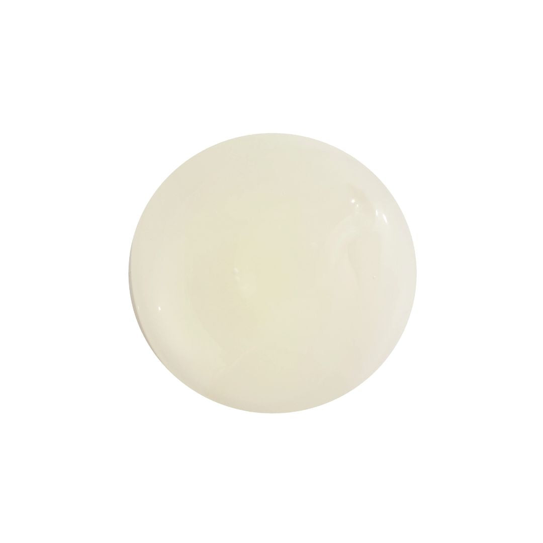 A single, round, translucent off-white cosmetic sponge tip or gel pad, shown against a solid white background.