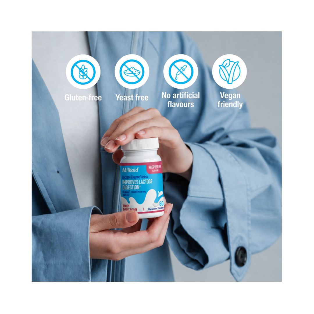 Milkaid Lactase Enzyme Tablets  being held by a woman in a blue jacket and allergen information at top of image