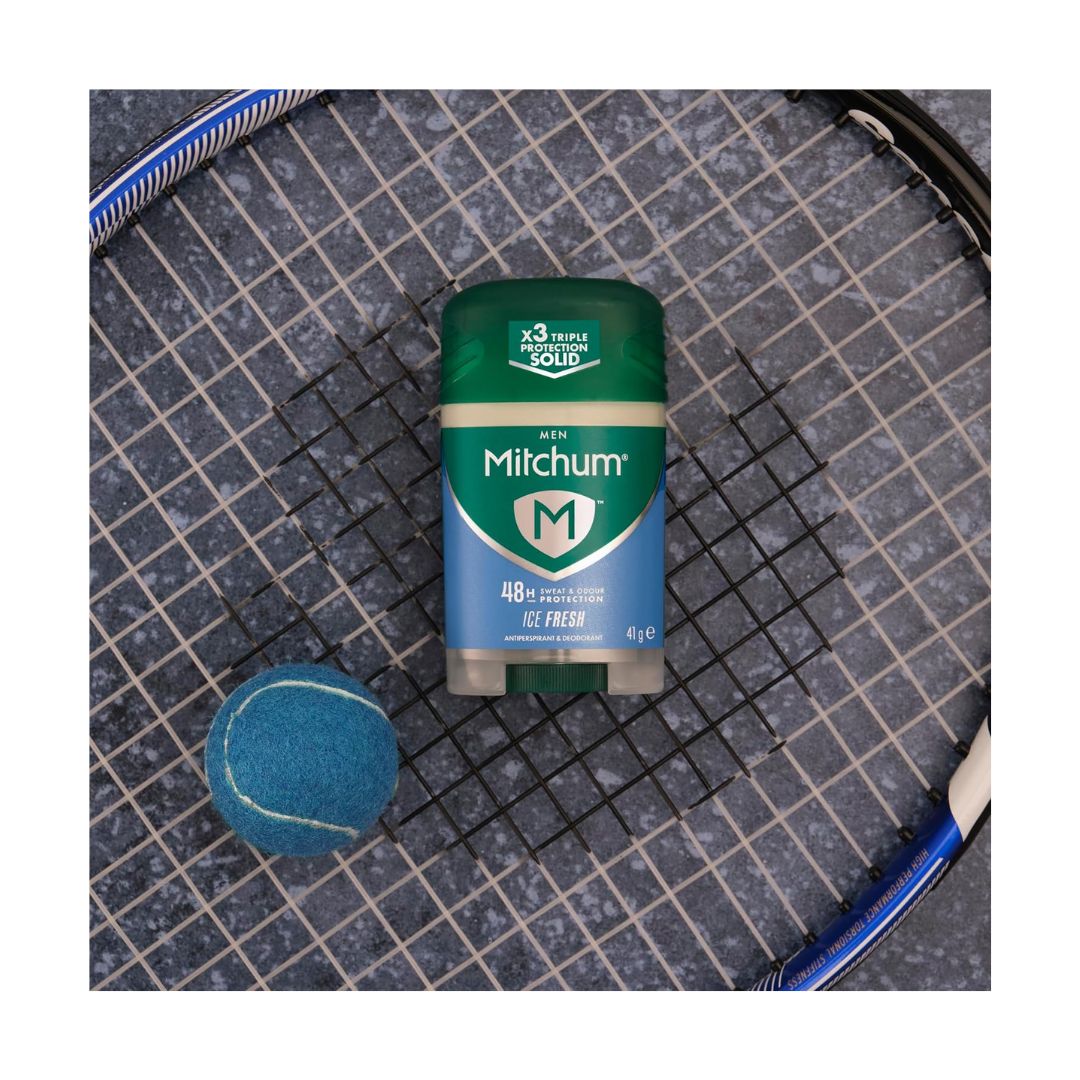 Mitchum Men Ice Fresh Antiperspirant Stick 41g on a tennis racket with a concrete background and blue tennis ball