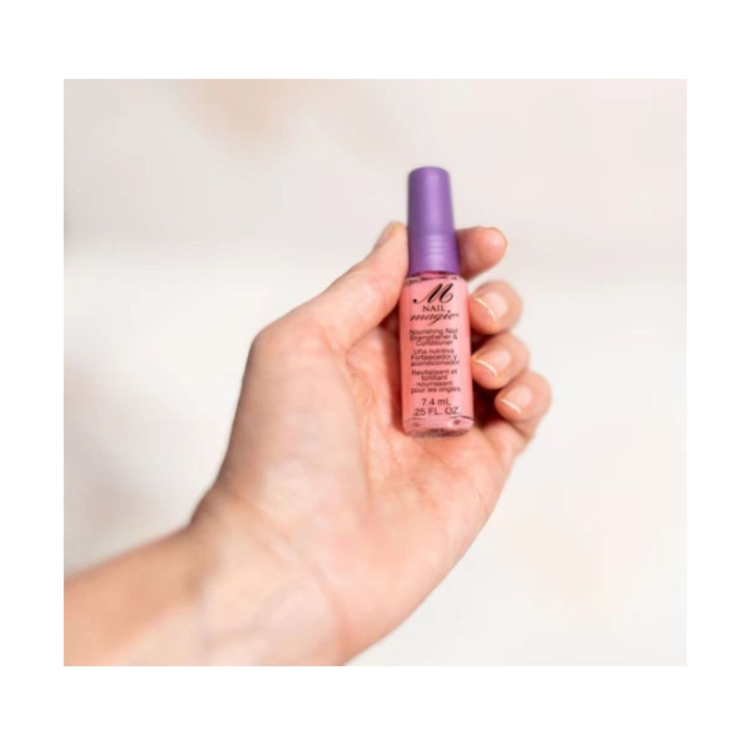 Nail Magic Nourish Nail Strengthener bottle in a persons hand