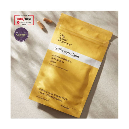 A gold stand-up pouch of The Silted Pharmacy Salfroson Calm supplement, shown on a light textured fabric background with two capsules and award badges.