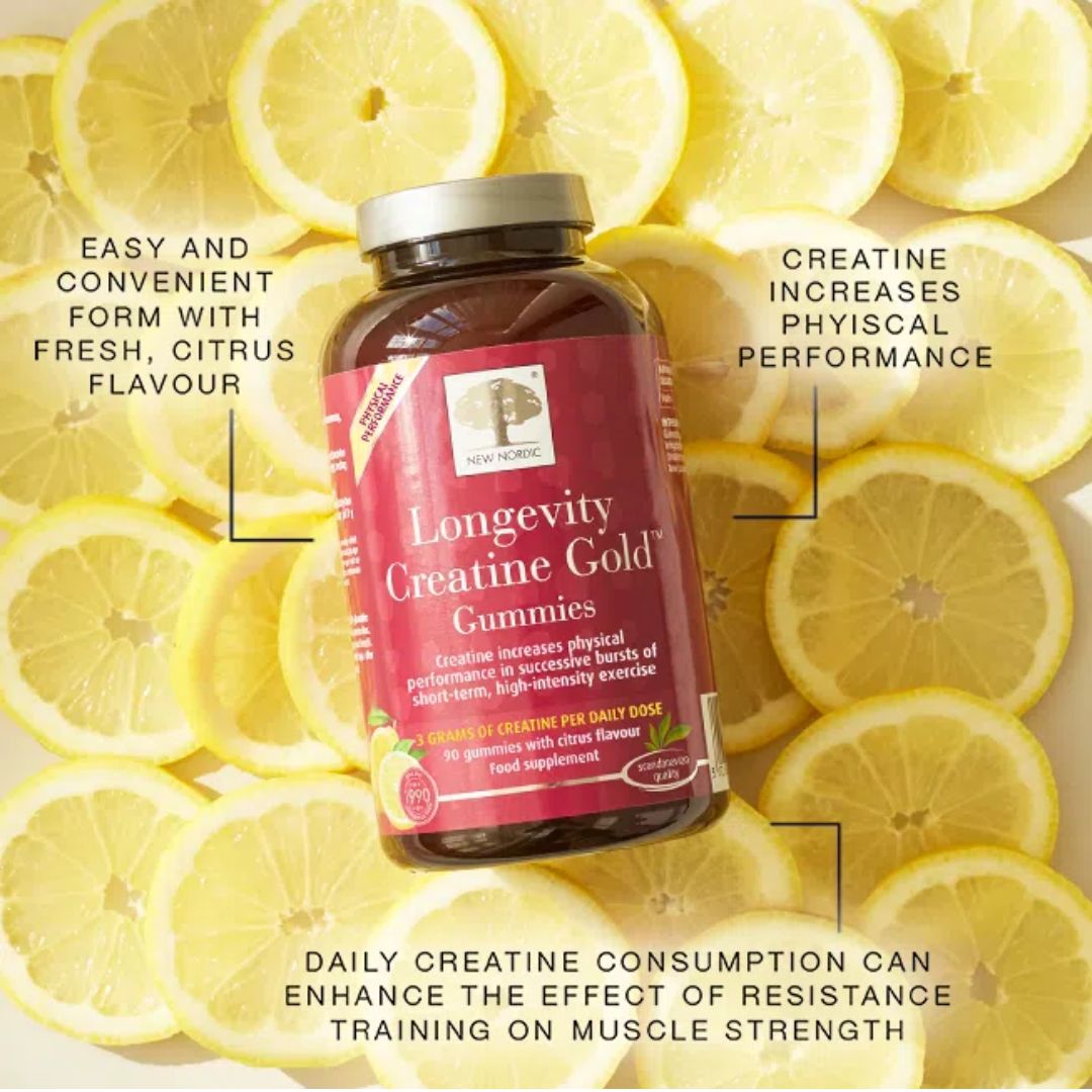 A bottle of Longevity Creatine Gold Gummies centered over a background of sliced yellow lemons, with promotional text callouts around it.