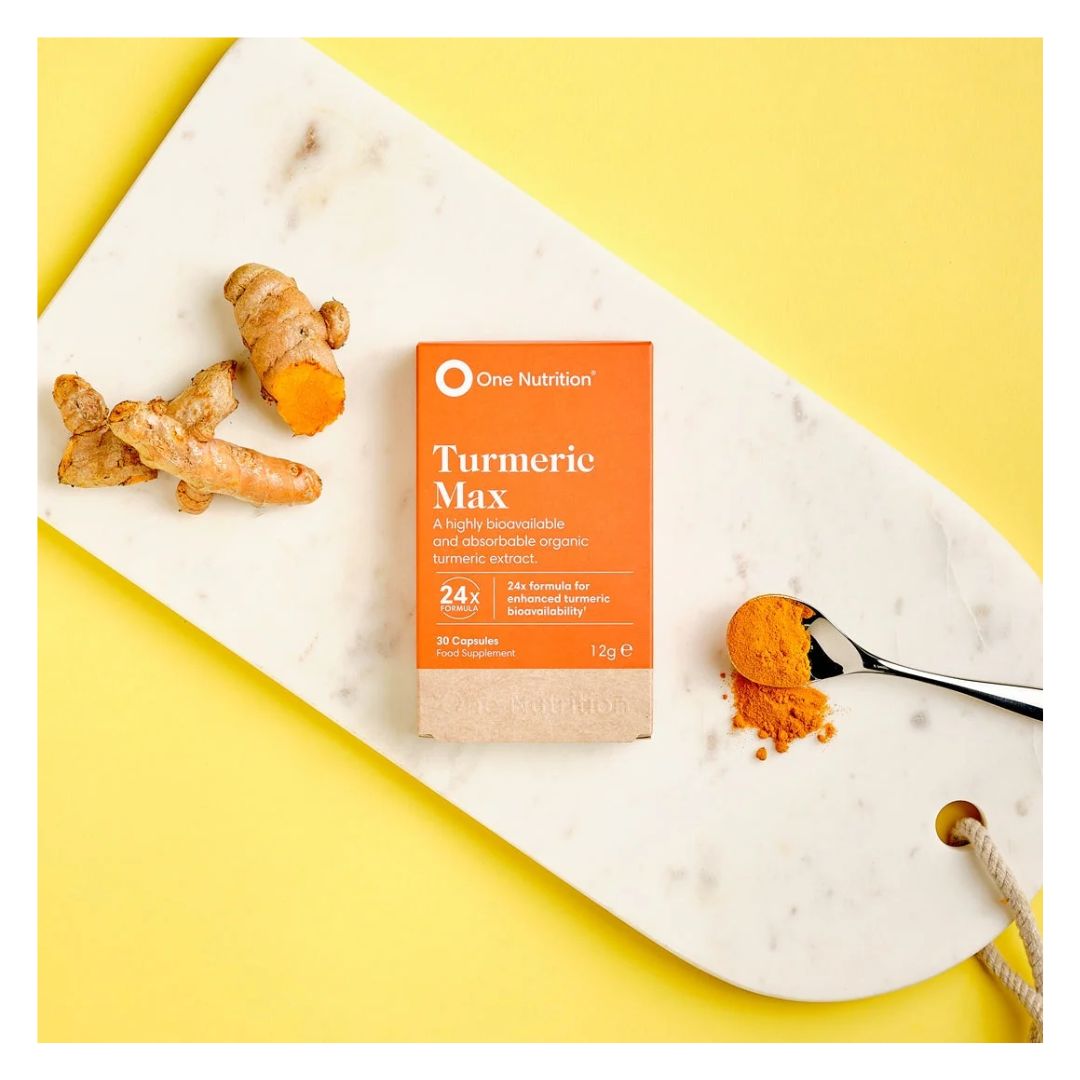 One Nutrition Turmeric Max 30 Capsules packaging on a marble board with turmeric powder and on a yellow background