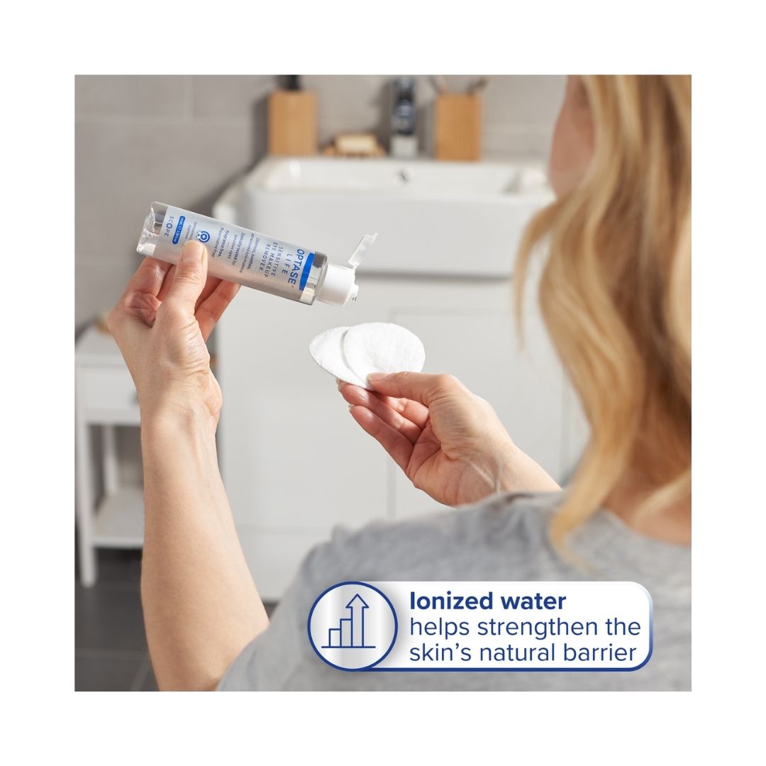 Optase Life Sensitive Eye Makeup Remover 100ml being poured onto acotton pads by a blond woman in a bathroom