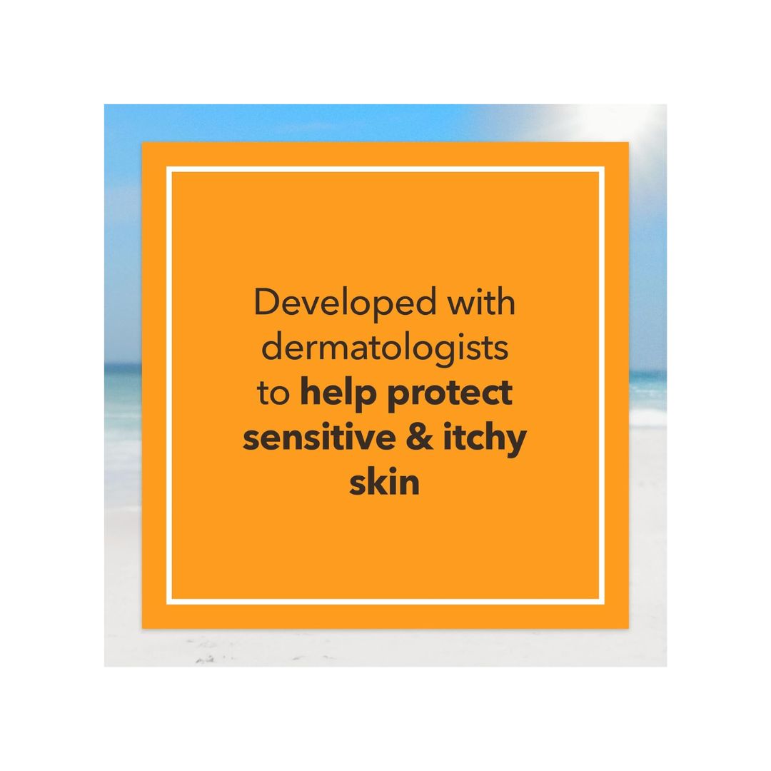 An orange square card with a white border and black text reading 'Developed with dermatologists to help protect sensitive & itchy skin,' centered over a blurred beach background with blue sky and pale sand.