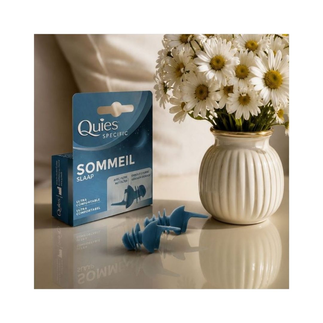 Quies Specific Sleep Ear Plugs and packaging on a marble countertop with a vase of flowers