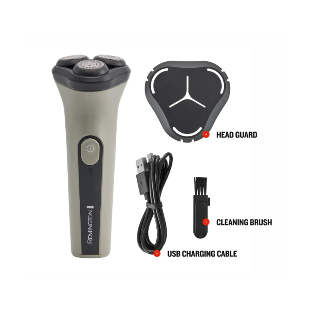 A Remington electric shaver shown with included accessories on a plain white background: a black and gray head guard, a black USB charging cable, a black cleaning brush, and the shaver itself. The shaver body is a warm gray/taupe with black trim and a central power button. Remington DuraCut Rotary Shaver box contents on a white background