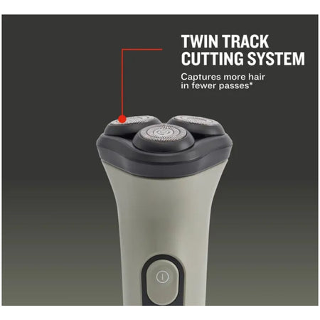 A close-up of an electric shaver handle with two visible cutting heads, shown on a dark gray background with overlaid text reading 'TWIN TRACK CUTTING SYSTEM' and a red pointer line indicating the cutting heads. Remington DuraCut Rotary Shaver 