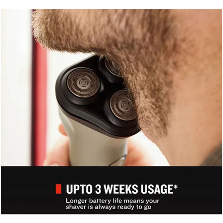 A close-up of a man shaving with an electric shaver, with a black and silver shaver against his beard. A black banner at the bottom reads 'UPTO 3 WEEKS USAGE* Longer battery life means your shaver is always ready to go'.Remington DuraCut Rotary Shaver