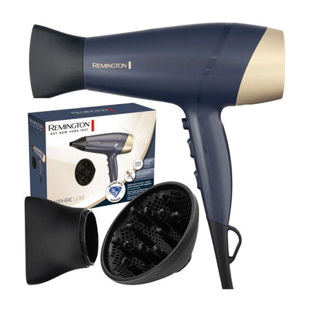 A Remington hair dryer in navy blue and champagne gold, shown with its retail box, a black concentrator nozzle, and a black diffuser on a plain white background. Sapphire luxe hairdyer