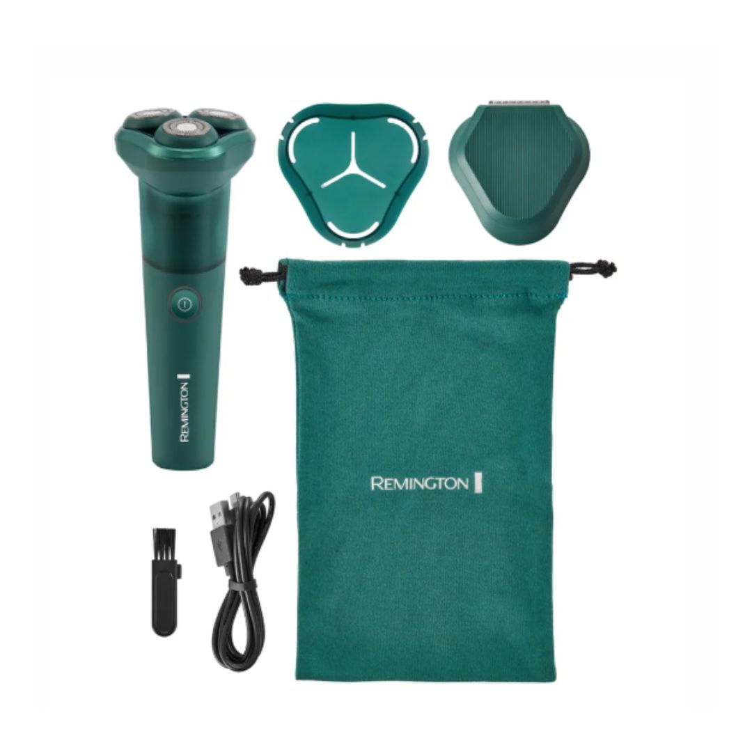 A Remington electric shaver set on a white background, including a dark teal green shaver, two interchangeable heads, a black cleaning brush, a black charging cable, and a matching dark teal drawstring pouch with the Remington brand name.