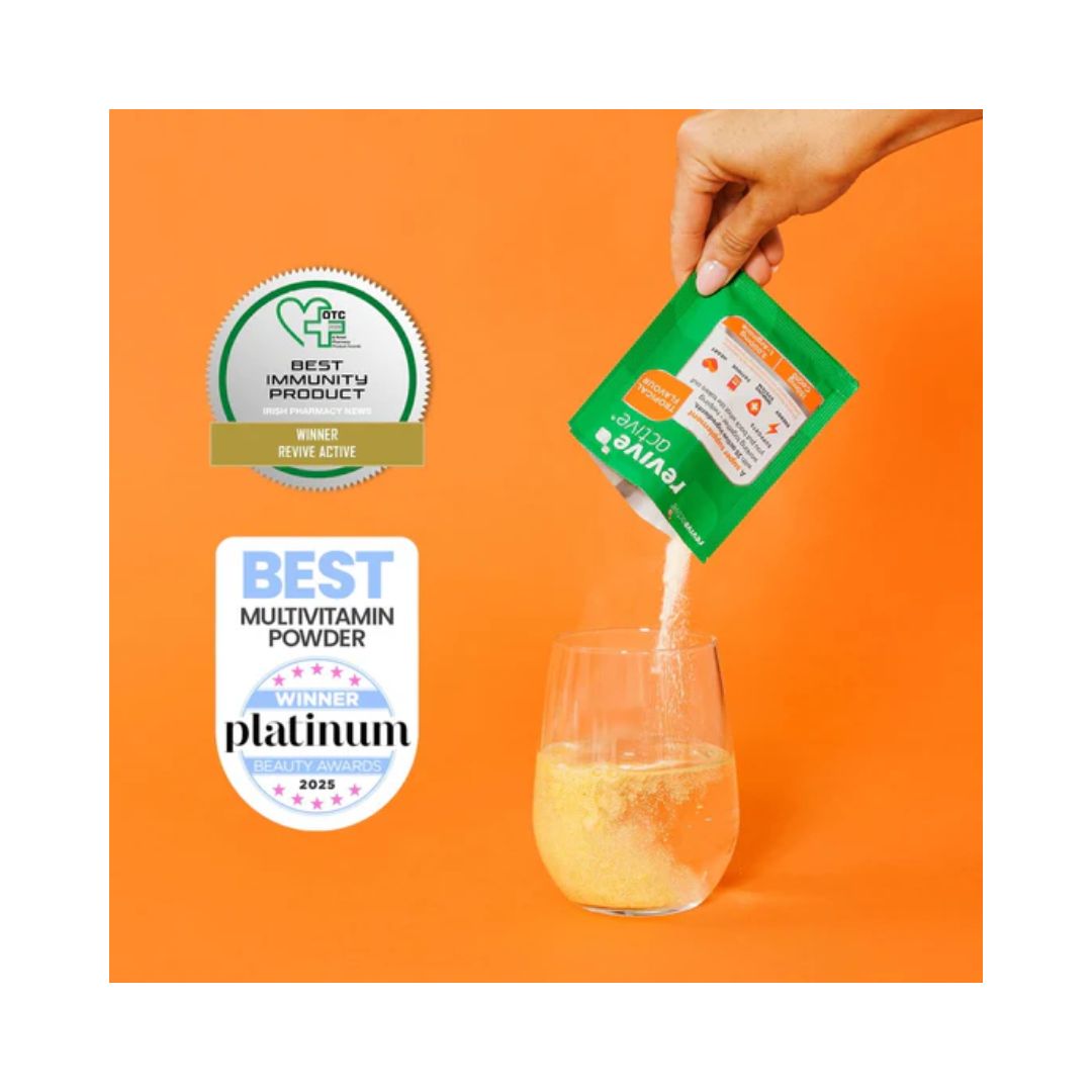 Revive Active Tropical being poured into a glass of water on an orange background