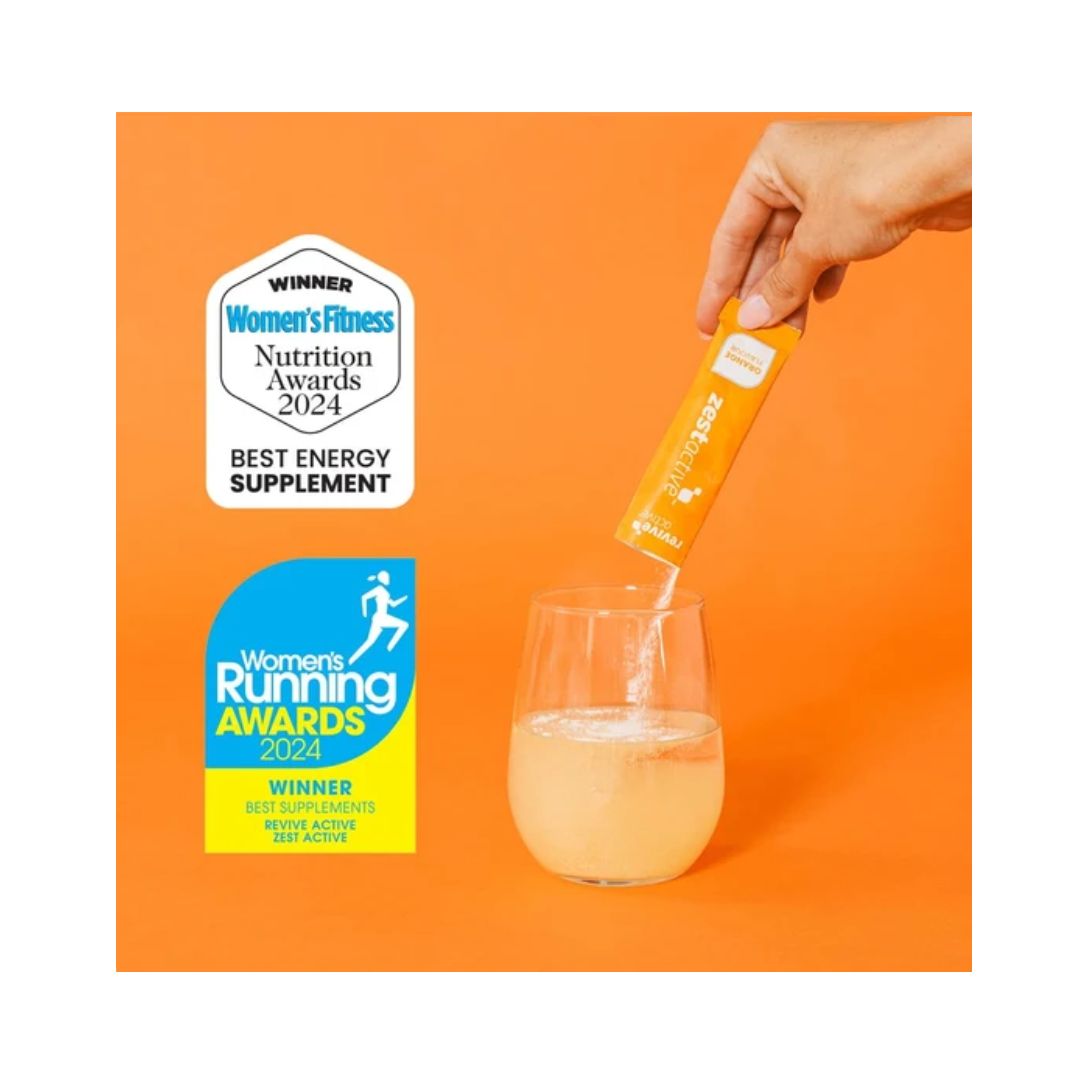Zest Active Orange being poured into a glass of water on an orange background