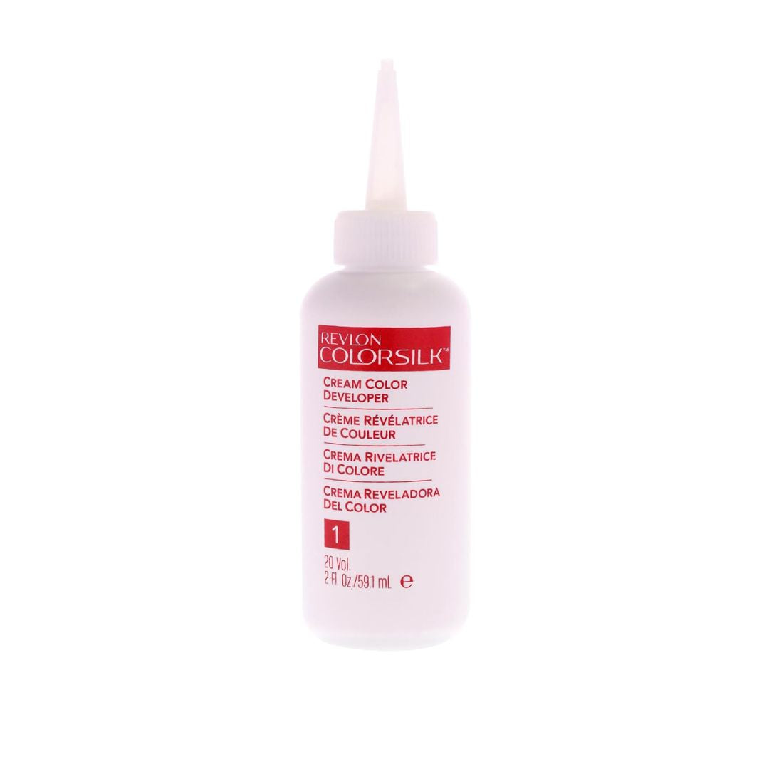 A bottle of Revlon ColorSilk Cream Color Developer, Step 1, with a pointed applicator cap, shown on a plain white background.