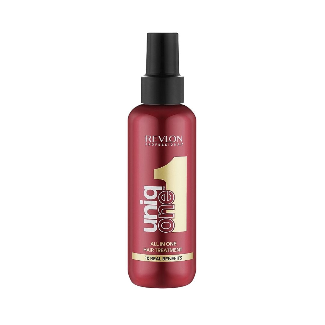A bottle of Revlon Uniq One All In One Hair Treatment, featuring a metallic red bottle with a black spray nozzle and gold and white text, set against a plain white background.