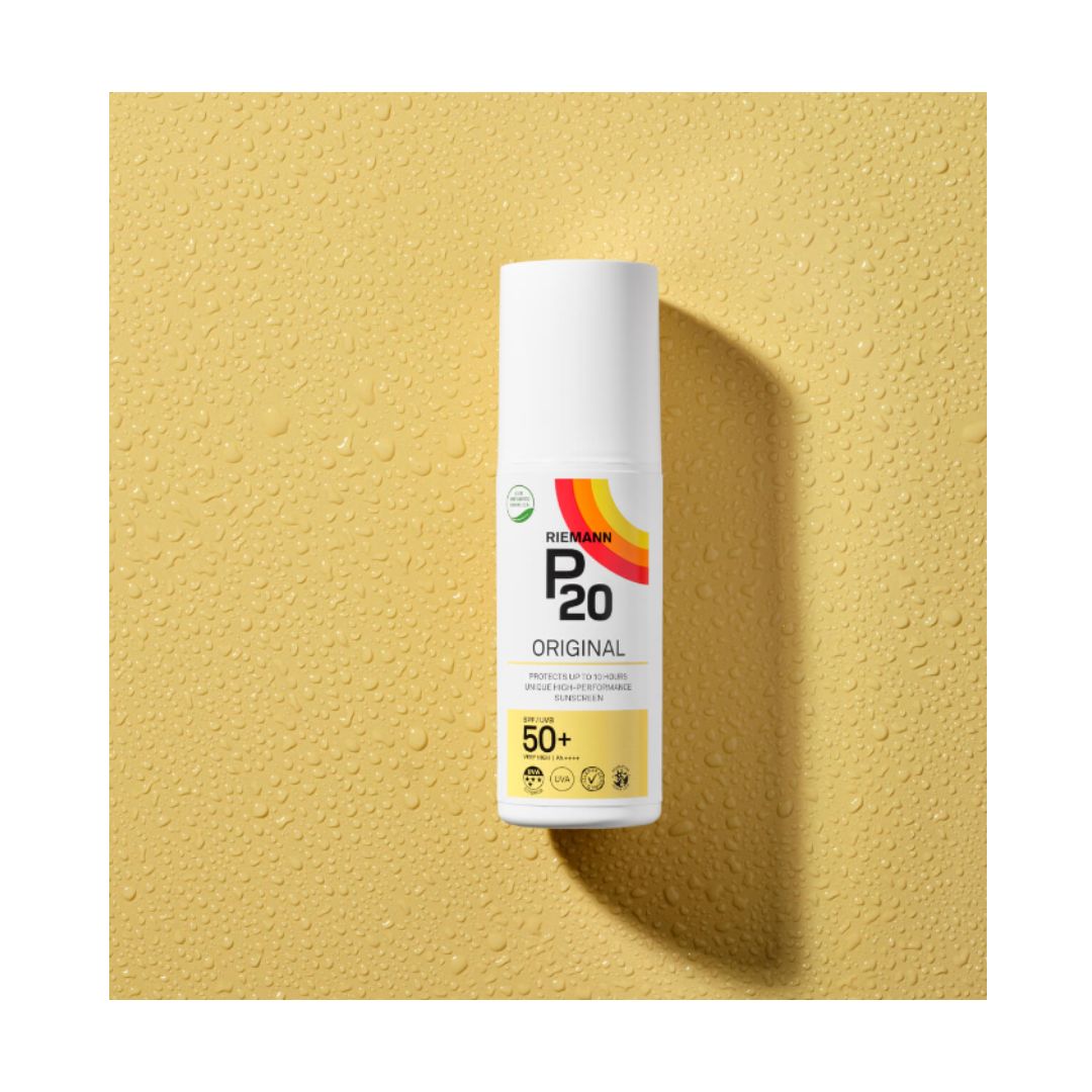 Riemann P20 Original SPF 50 Spray 100ml bottle on a wet yellow background
