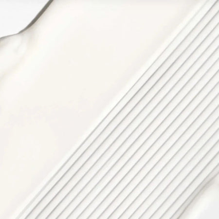 A close-up of a white textured surface with diagonal ridges and a smooth white area on the left.