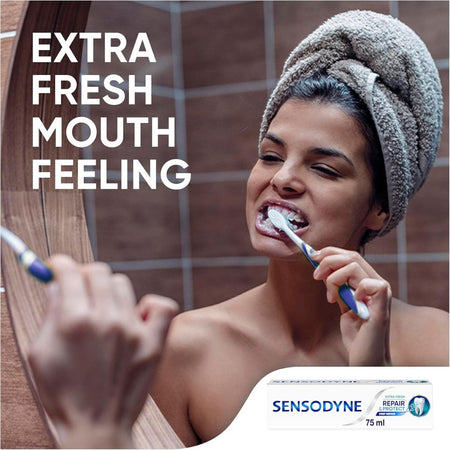 Woman brushing her teeth with a towel on her head, Sensodyne advertisement.