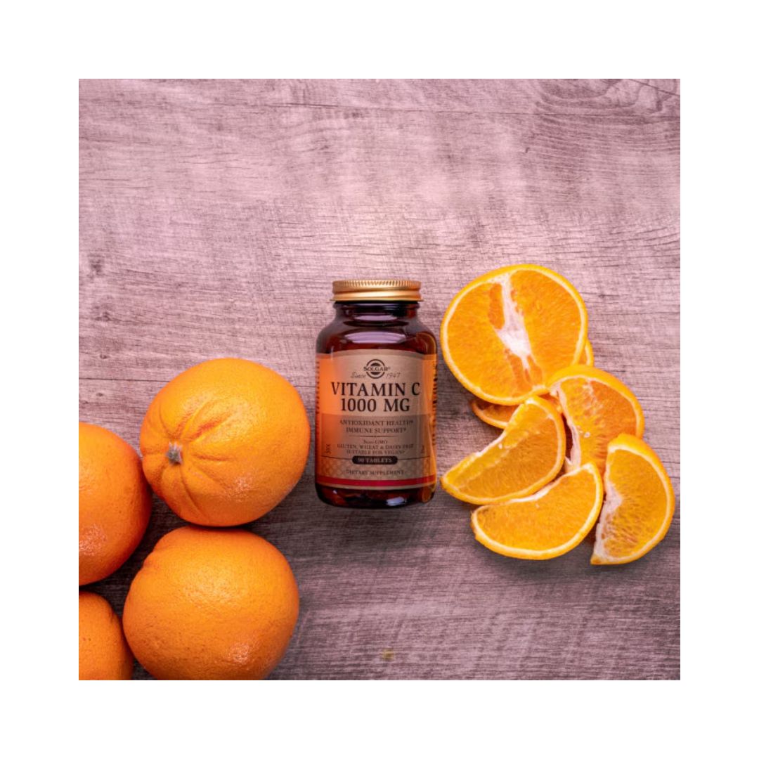 Solgar Vitamin C 1000mg 100 Capsules container on wooden floor with oranges 
