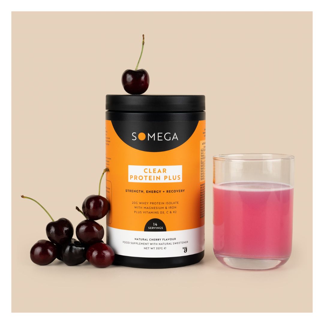Somega Clear Protein Plus Cherry container surrounded by cherries and with a glass of pink liquid