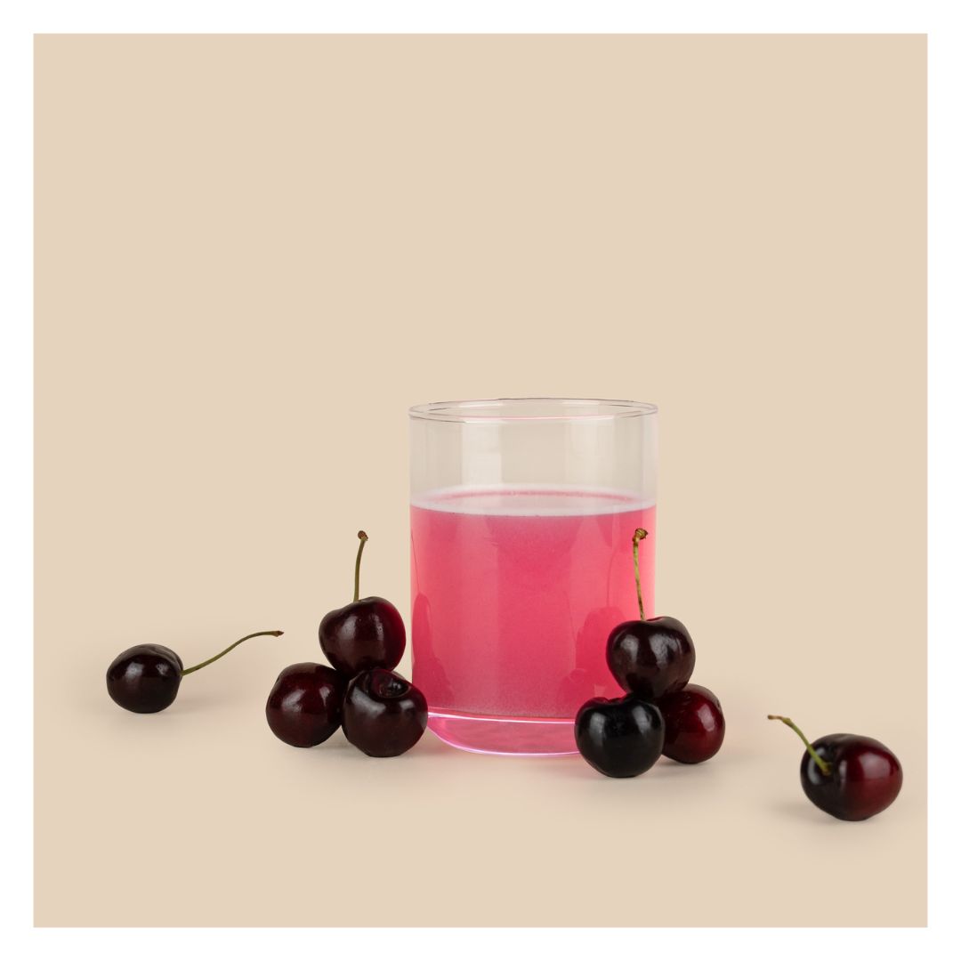 Somega Clear Protein Plus Cherry in liquid formin a glass surrounded by cherries