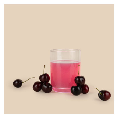 Somega Clear Protein Plus Cherry in liquid formin a glass surrounded by cherries