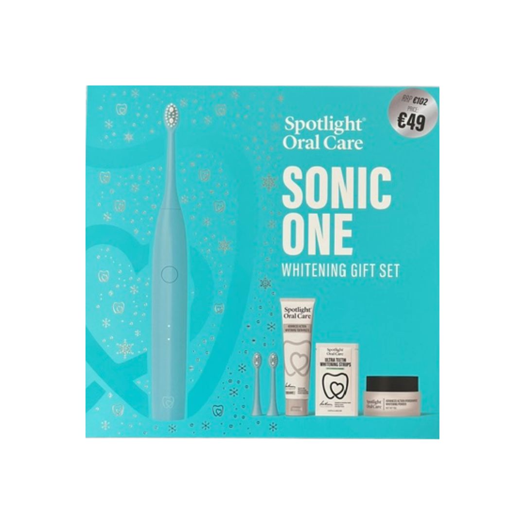Spotlight Oral Care Sonic One Whitening Gift Set in its retail packaging, featuring a light blue electric toothbrush, two replacement heads, a tube, a box, and a jar on a bright turquoise background.