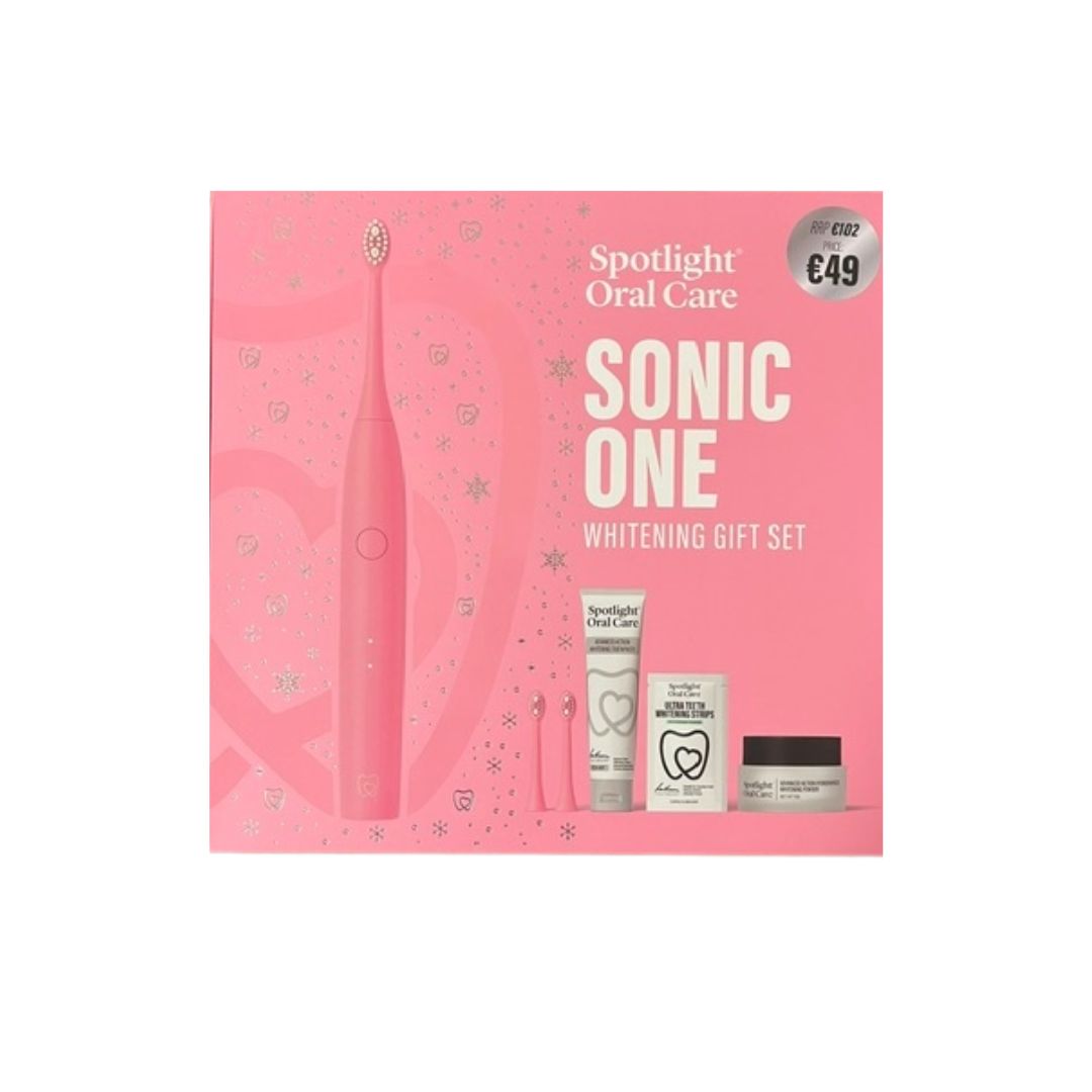 Spotlight Oral Care Sonic One Whitening Gift Set in a pink box, featuring a pink electric toothbrush and three oral care items including a tube, a small bottle, and a jar.