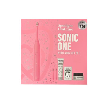 Spotlight Oral Care Sonic One Whitening Gift Set in a pink box, featuring a pink electric toothbrush and three oral care items including a tube, a small bottle, and a jar.
