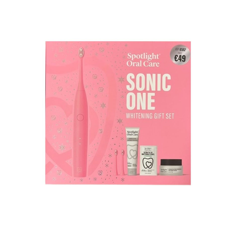 Spotlight Oral Care Sonic One Whitening Gift Set in a pink box, featuring a pink electric toothbrush and three oral care items including a tube, a small bottle, and a jar.