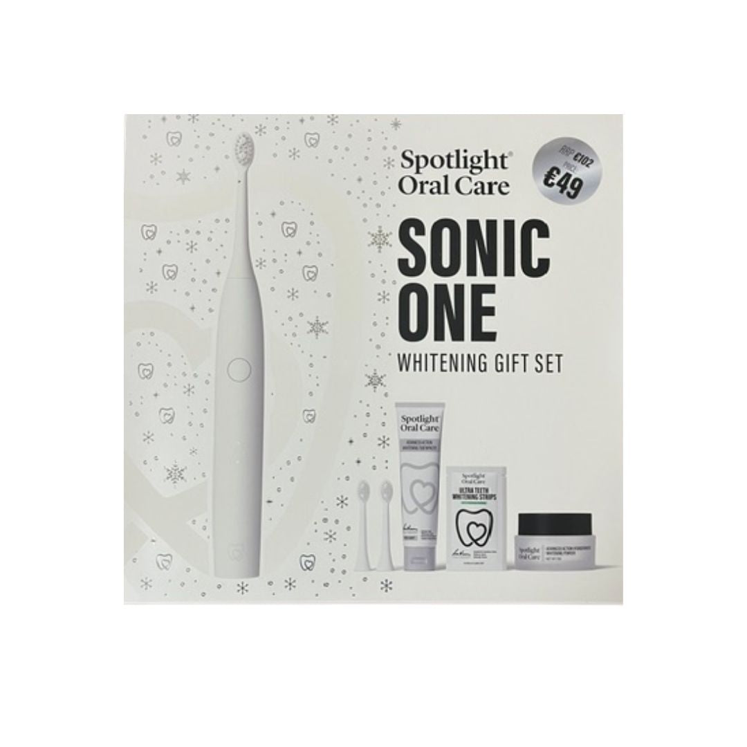 Spotlight Oral Care Sonic One Whitening Gift Set in its retail packaging, featuring a white electric toothbrush, toothpaste, floss, and a whitening cream jar.