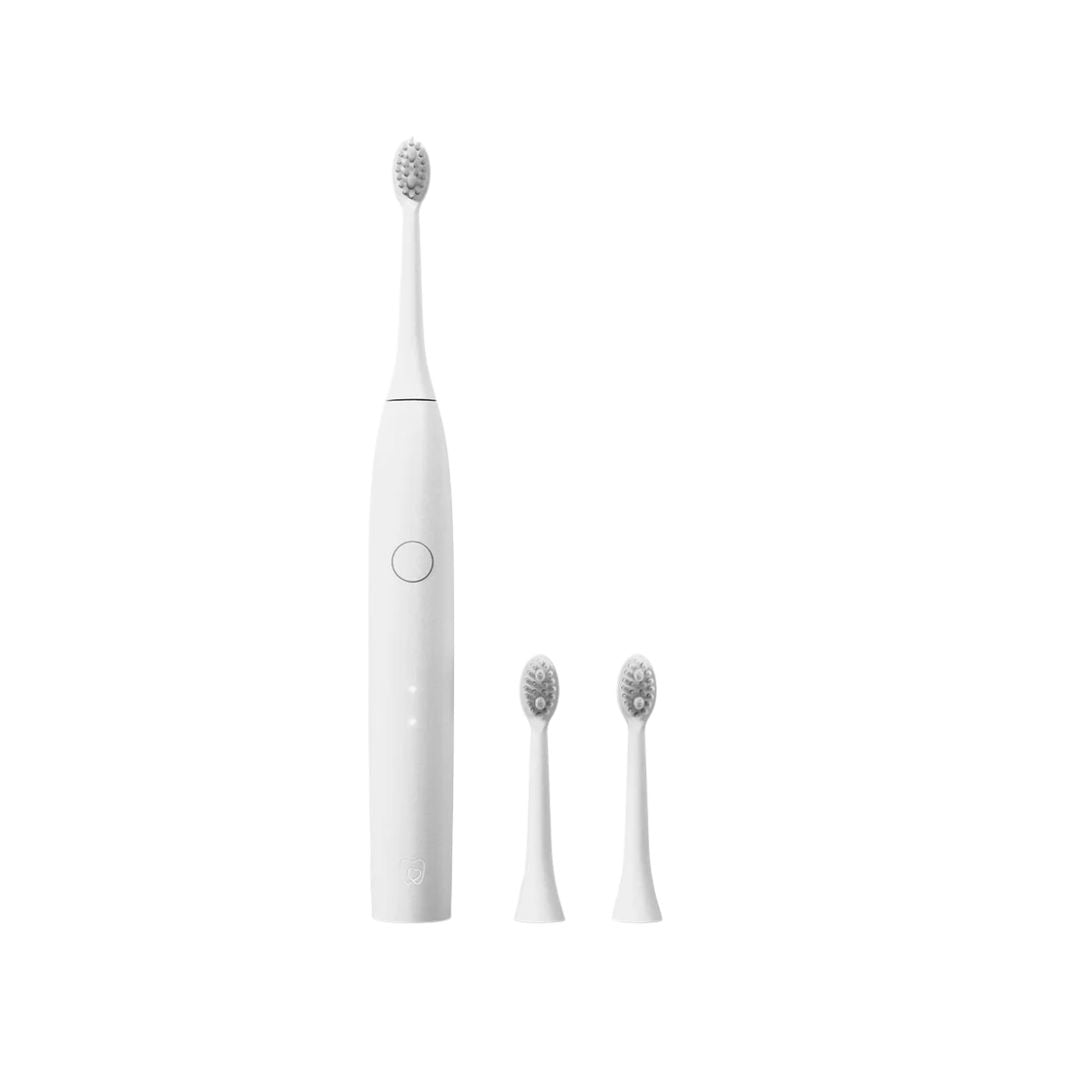 A white electric toothbrush with three interchangeable brush heads displayed vertically against a solid white background.