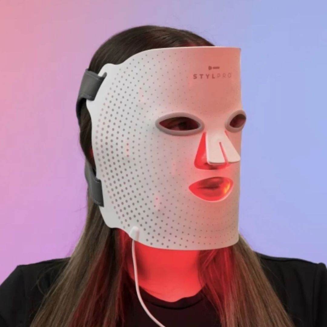 STYLPRO Wavelength LED Face Mask being used by a woman who has it on the infrared setting