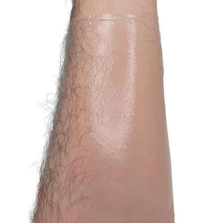 A tegaderm drssing after being applied to a leg with a white background