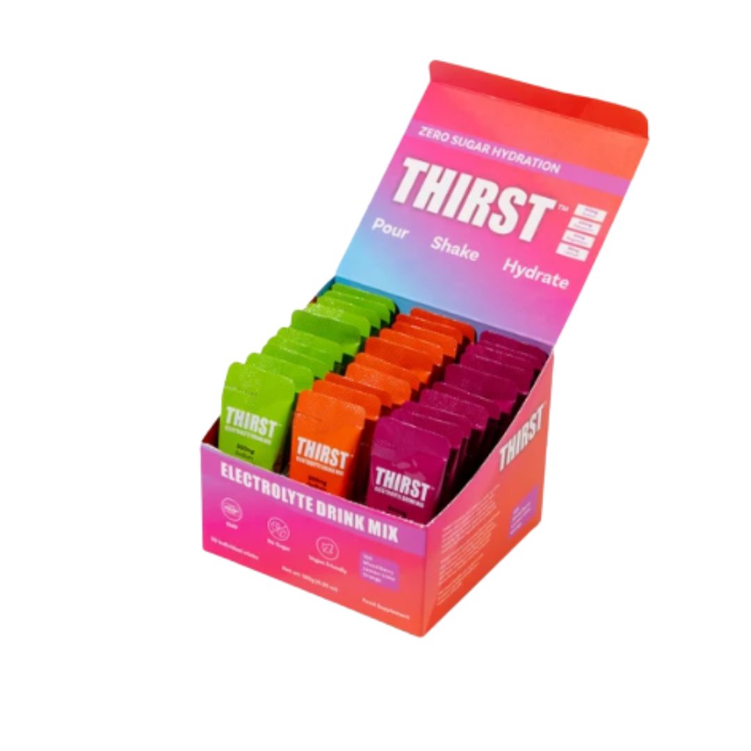 A retail display box of Thirst Electrolyte Drink Mix, showing multiple single-serve packets in green, orange, and purple arranged inside an open box with a pink and blue gradient lid.