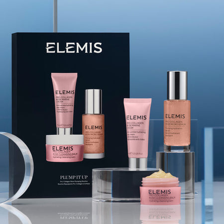 Elemis skincare products on a reflective surface with a blue gradient background