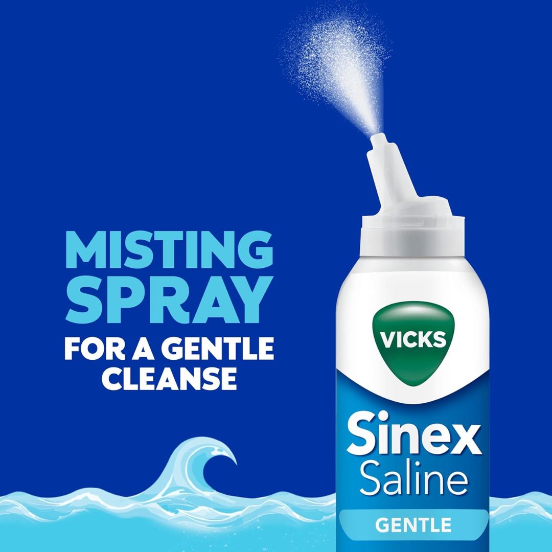Vicks Sinex Saline Gentle Misting Spray bottle on a blue background with text reading 'MISTING SPRAY FOR A GENTLE CLEANSE' and a white spray mist shown above the nozzle.