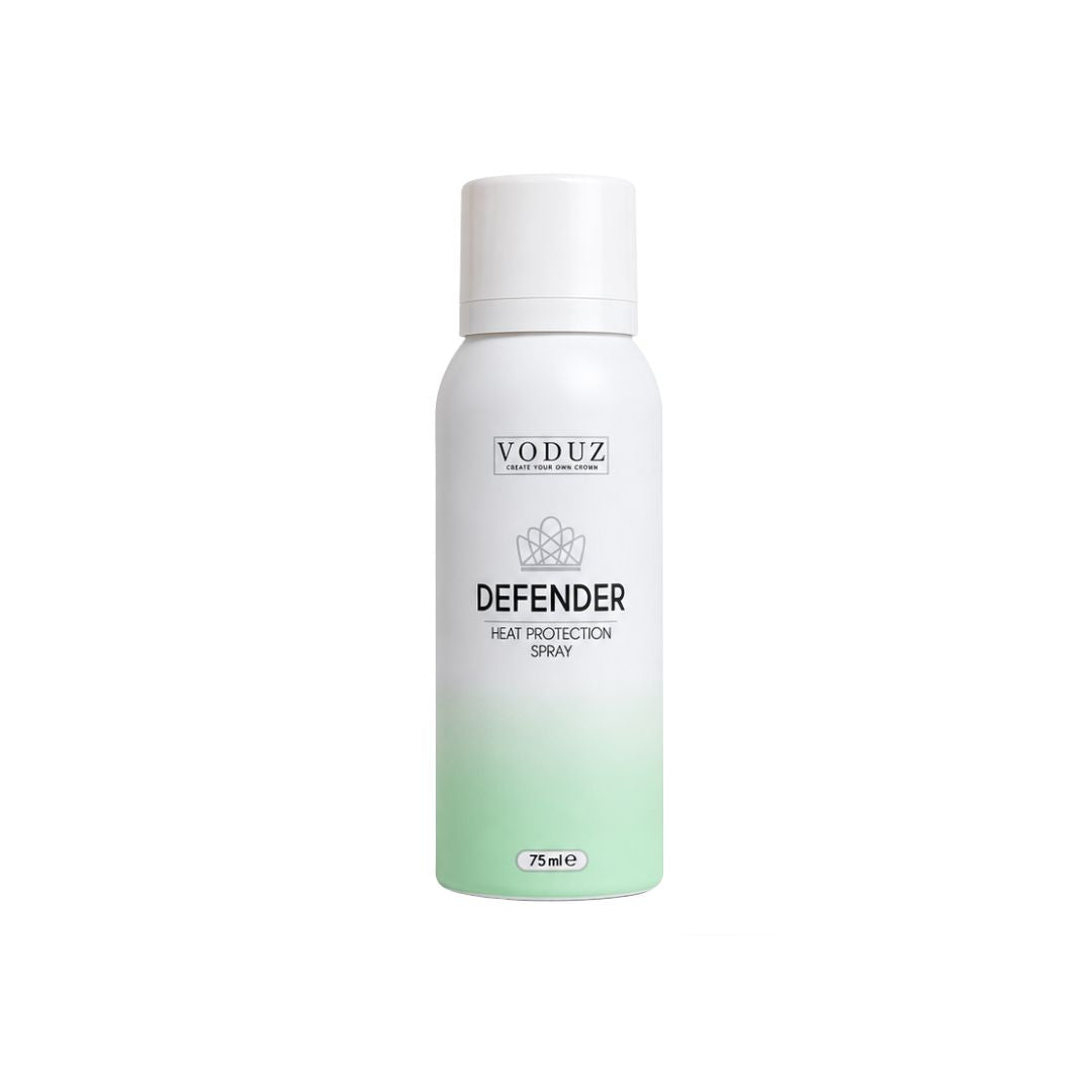 A white aerosol can of VODUZ Defender Heat Protection Spray with a white cap, featuring a white-to-light-green gradient at the bottom, on a solid white background.