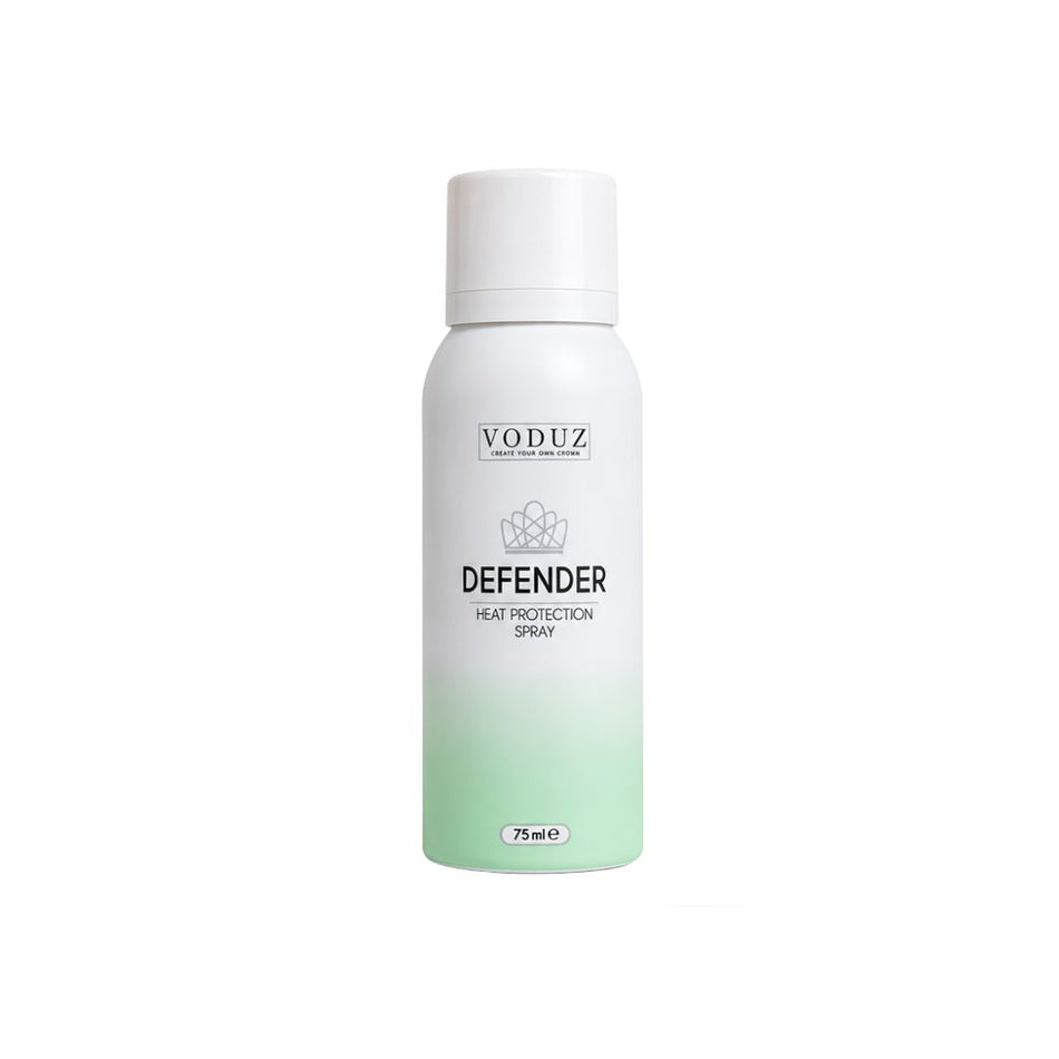 A white aerosol can of VODUZ Defender Heat Protection Spray with a white cap, featuring a white-to-light-green gradient at the bottom, on a solid white background.