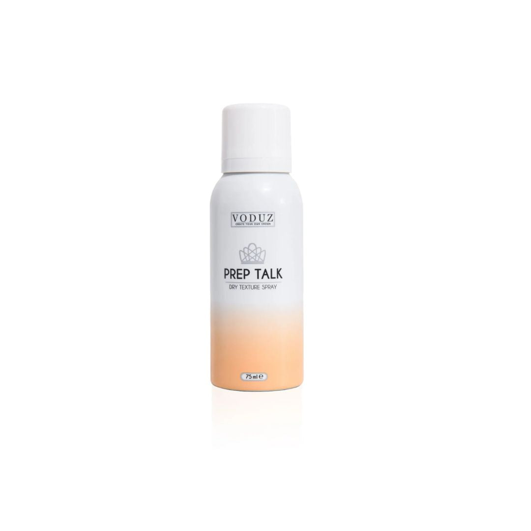 A white cylindrical bottle of VODUZ Prep Talk Dry Texture Spray with a white cap, featuring a white-to-soft-peach gradient at the bottom, set against a plain white background.