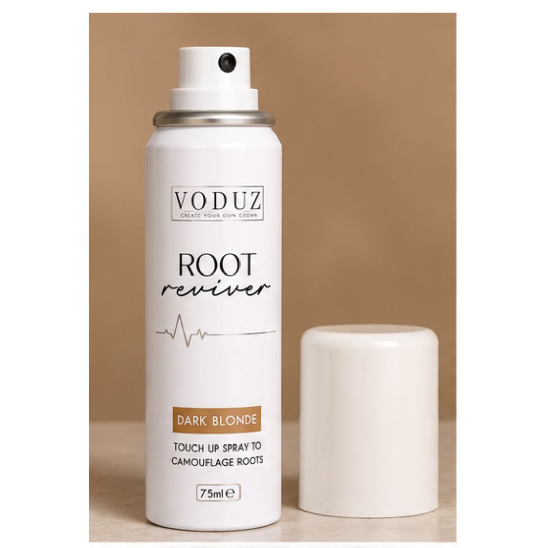 A white VODUZ Root Reviver touch-up spray canister with its cap off, displayed next to it on a light wooden surface against a solid tan background.