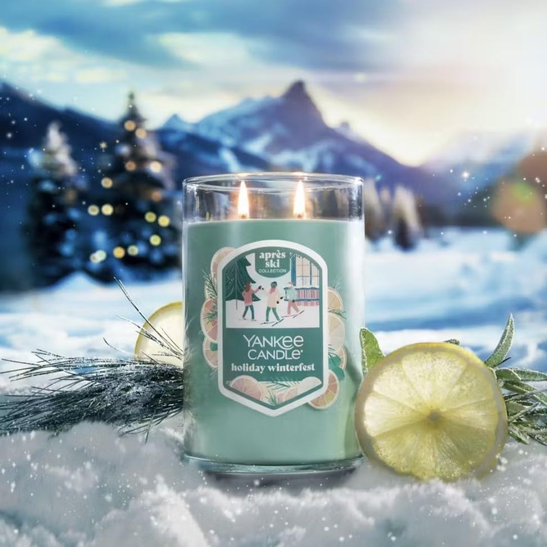 Yankee Candle Large Jar Holiday Winterfest on a snowy background with a slice of lemon