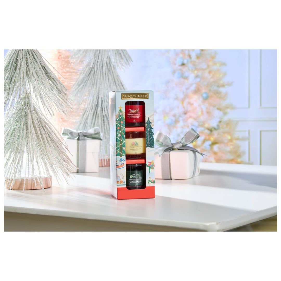 Yankee Candle Mini Votive Set on a white table with christmas decorations in the background