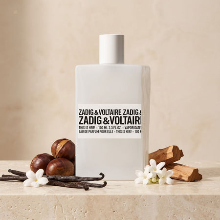 Zadig & Voltaire This Is Her! Eau de Parfum on a cream background surrounded by ingredients