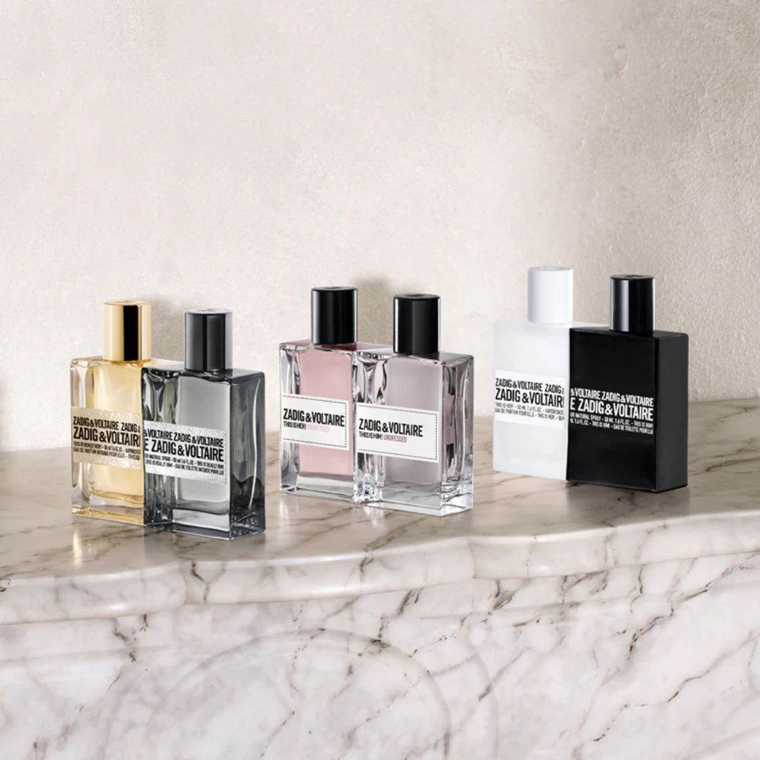 Collection of Zadig & Voltaire perfume bottles on a marble surface