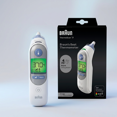 Braun ThermoScan 7 digital forehead thermometer shown next to its black retail packaging box on a light gray studio background.